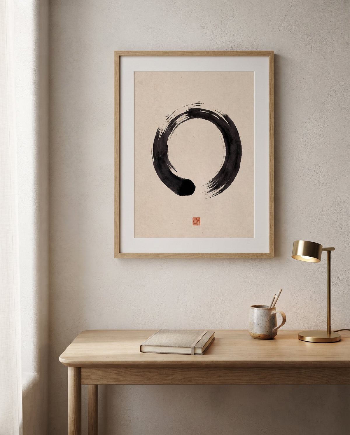 Ensō print above a small oak desk